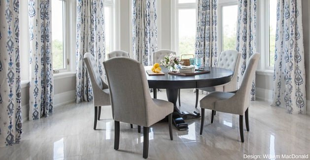 traditional dining room with large round table and marble-look tile floors